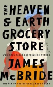 In the image, a Black male figure wearing a blue hat and white shirt carries a round red object (possibly a water jar). Text says "THE HEAVEN & EARTH GROCERY SHORE a novel NEW YORK TIMES BESTSELLING AUTHOR JAMES MCBRIDE WINNER OF THE NATIONAL BOOK AWARD"