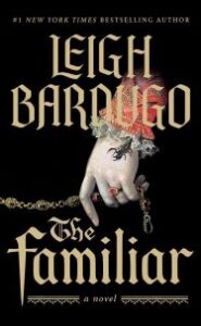 Text says "#1 NEW YORK TIMES BESTSELLING AUTHOR LEIGH BARDUGO THE FAMILIAR a novel". Image of a hand with a beaded red sleeve with lace at the wrist, wearing a red stone ring and holding a rosary. A black scorpion is crawling out of the sleeve.