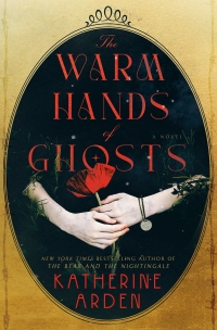 Image of black oval cameo with white feminine hands holding a poppy with dog tags for a bracelet. Text says "The Warm Hands of Ghosts New York Times Bestselling Author of The Bear and The Nightingale Katherine Arden"